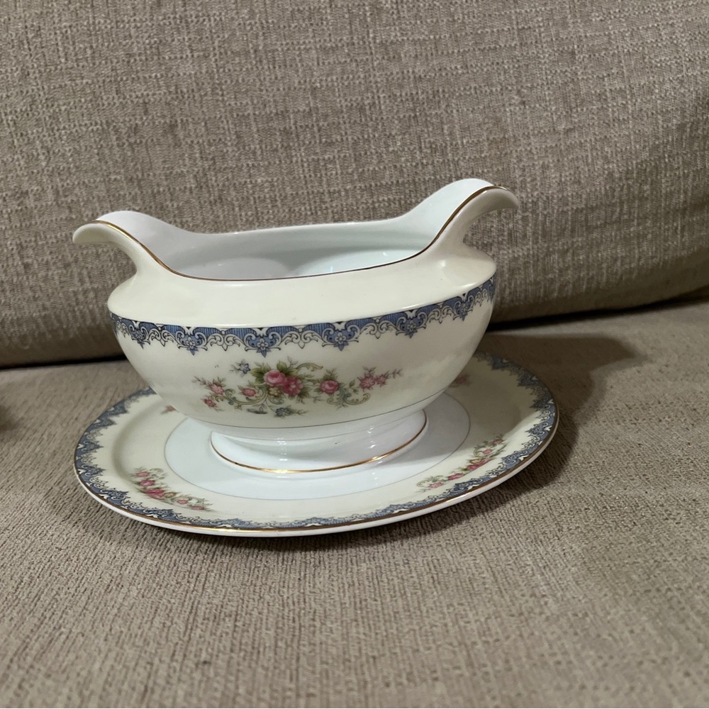 Meito China NSP Floral White gravy boat with attached underplate.
